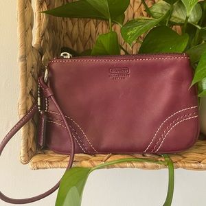 Maroon, leather, Coach wristlet. Perfect for carrying the necessities.